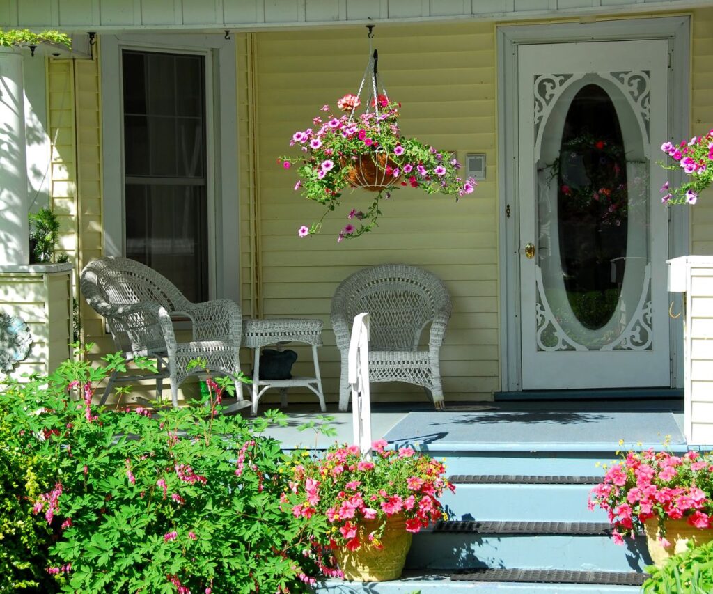 summer front porch decor white wicker furniture and colorful plants